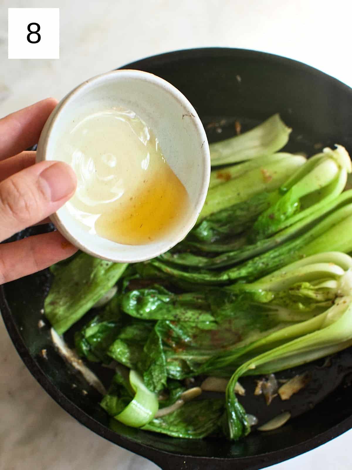 drizzling honey over seasoned bok choy for additional flavor.