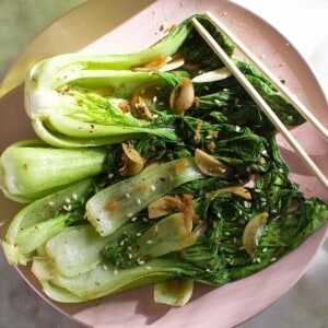 cooked bok choy, seasoned with garlic and ginger, on a plate.