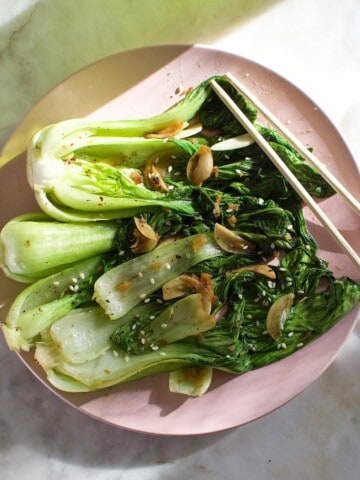 cooked bok choy, seasoned with garlic and ginger, on a plate.