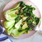 cooked bok choy, seasoned with garlic and ginger, on a plate.