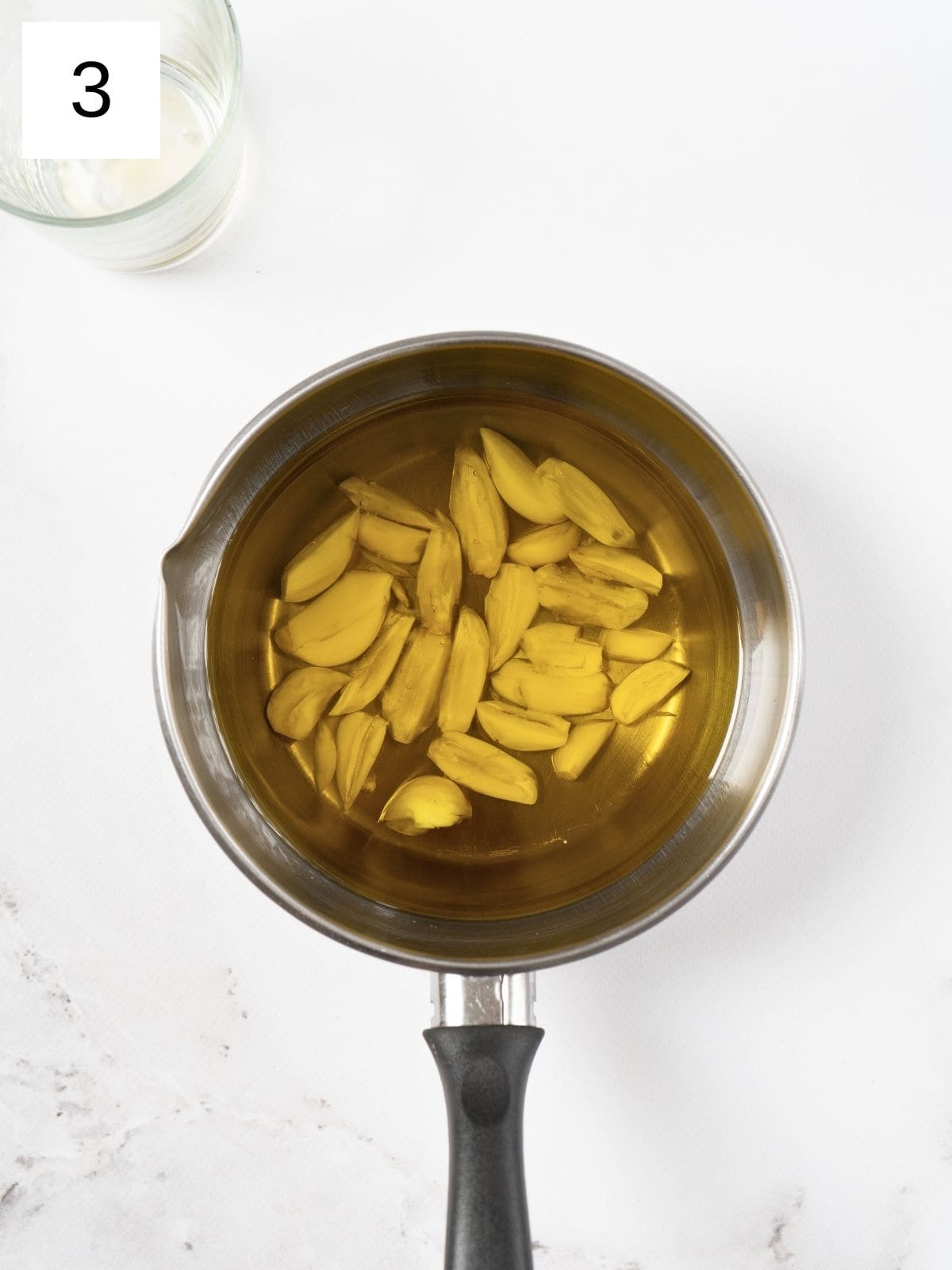 pressed garlic cloves in a pan of olive oil.