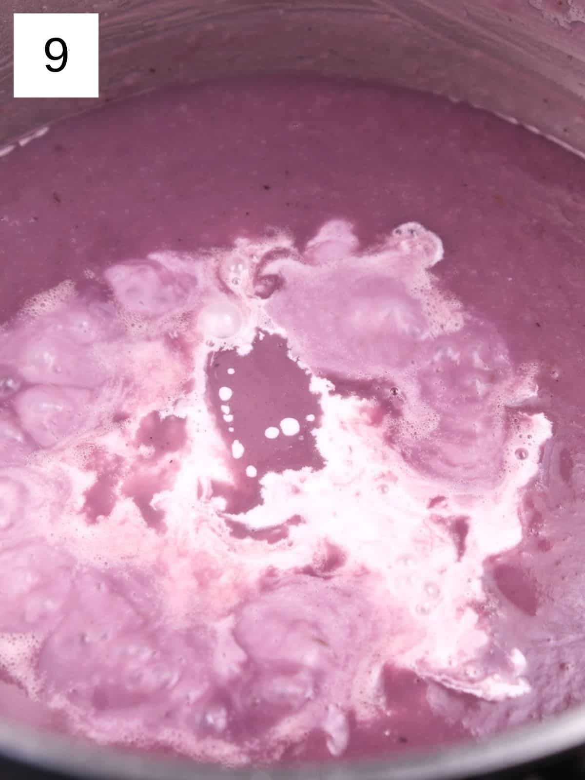 purple sweet potato soup blended with coconut cream simmering in a pot.