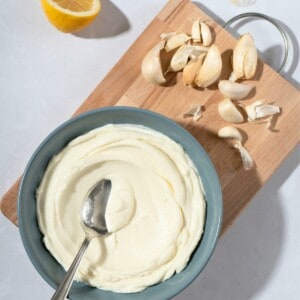 white, creamy toum garlic mayo in a ceramic bowl.