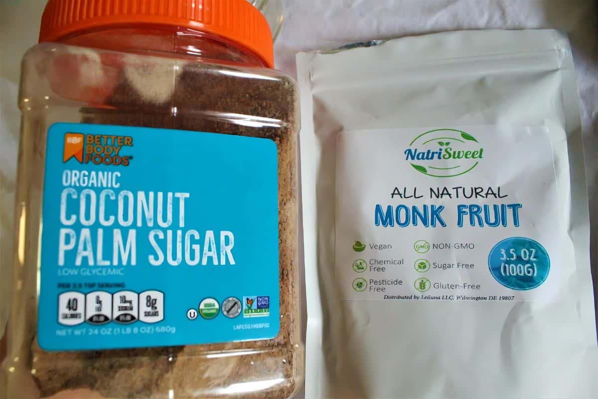 A jar of organic coconut palm sugar next to packed all natural monk fruit extract.