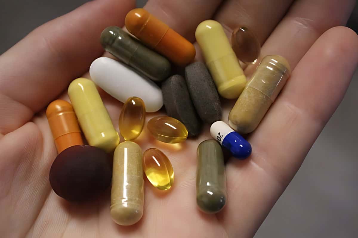 Several colorful pills in an open hand.