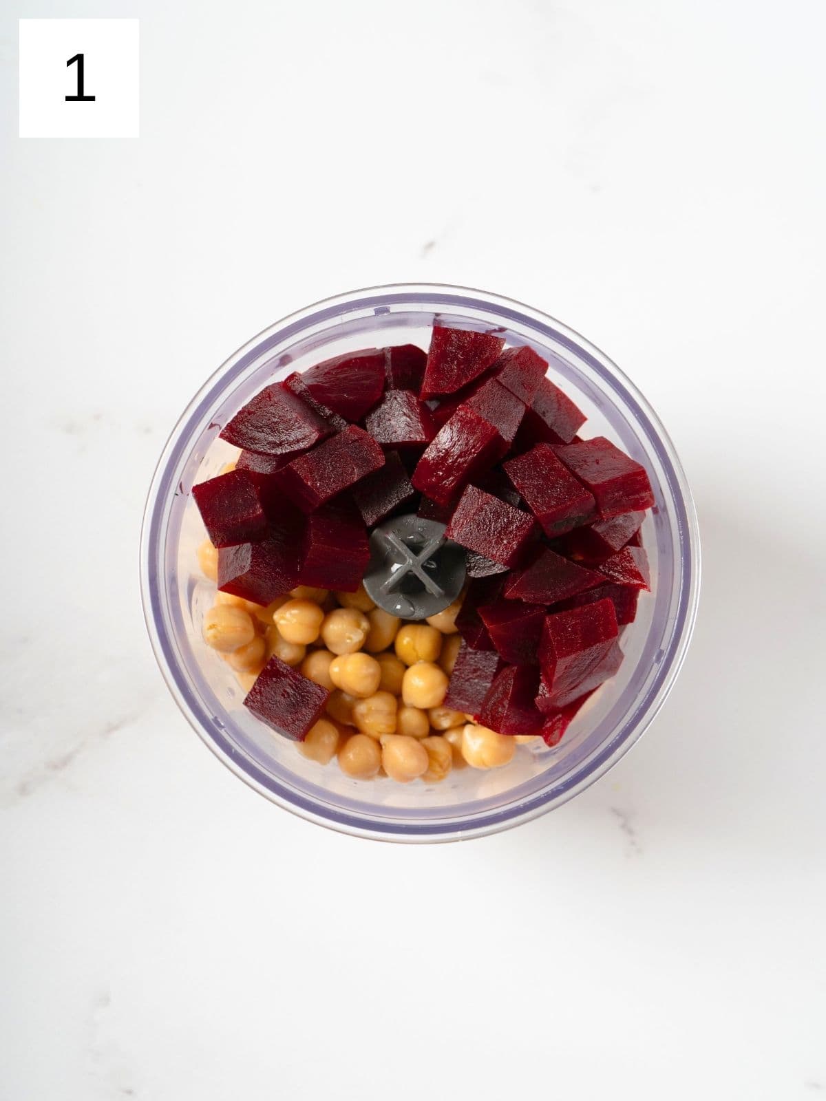 sliced beets and chickpeas in a food processor.