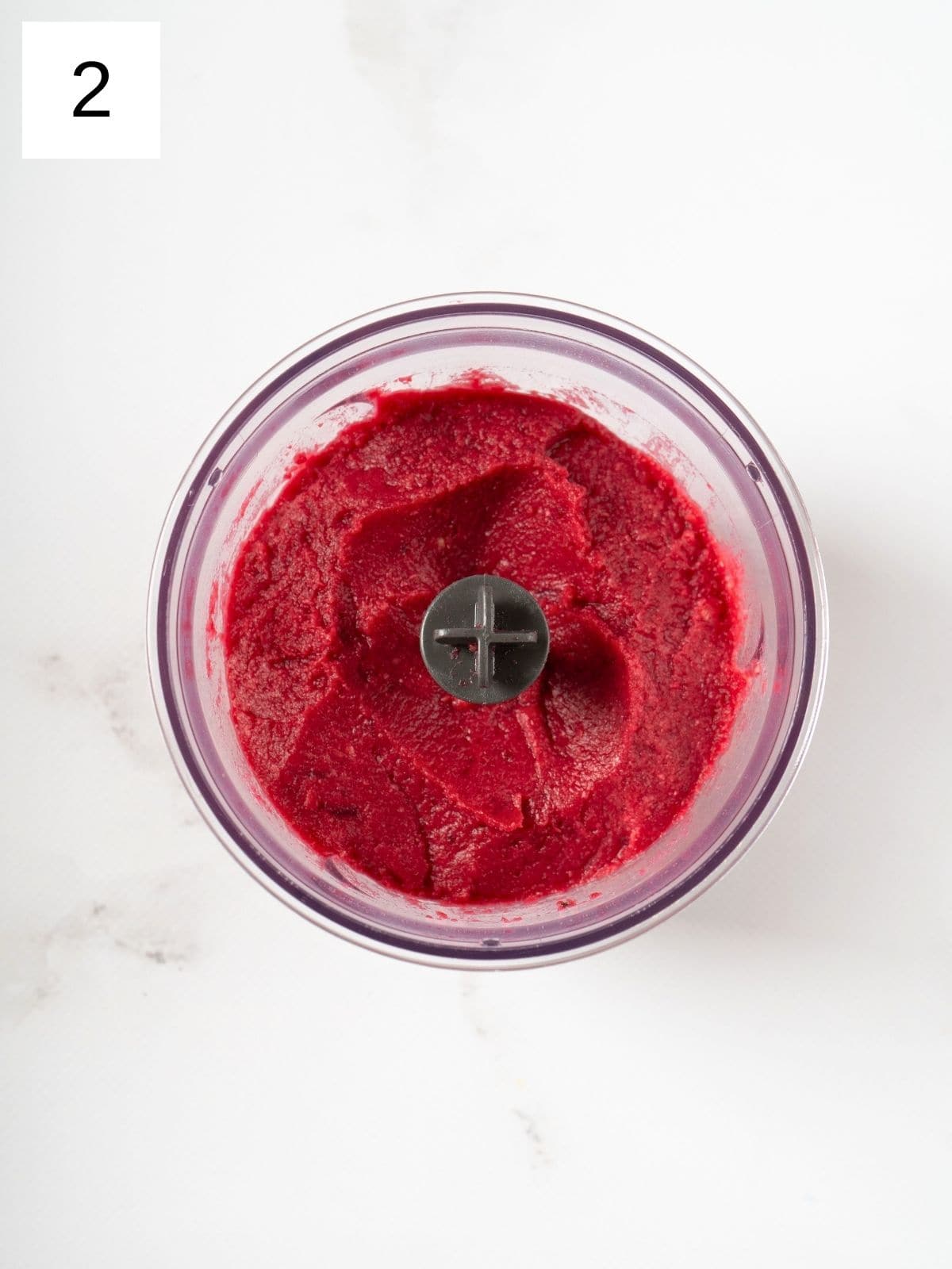 blended mixture of sliced beets and chickpeas in a food processor.
