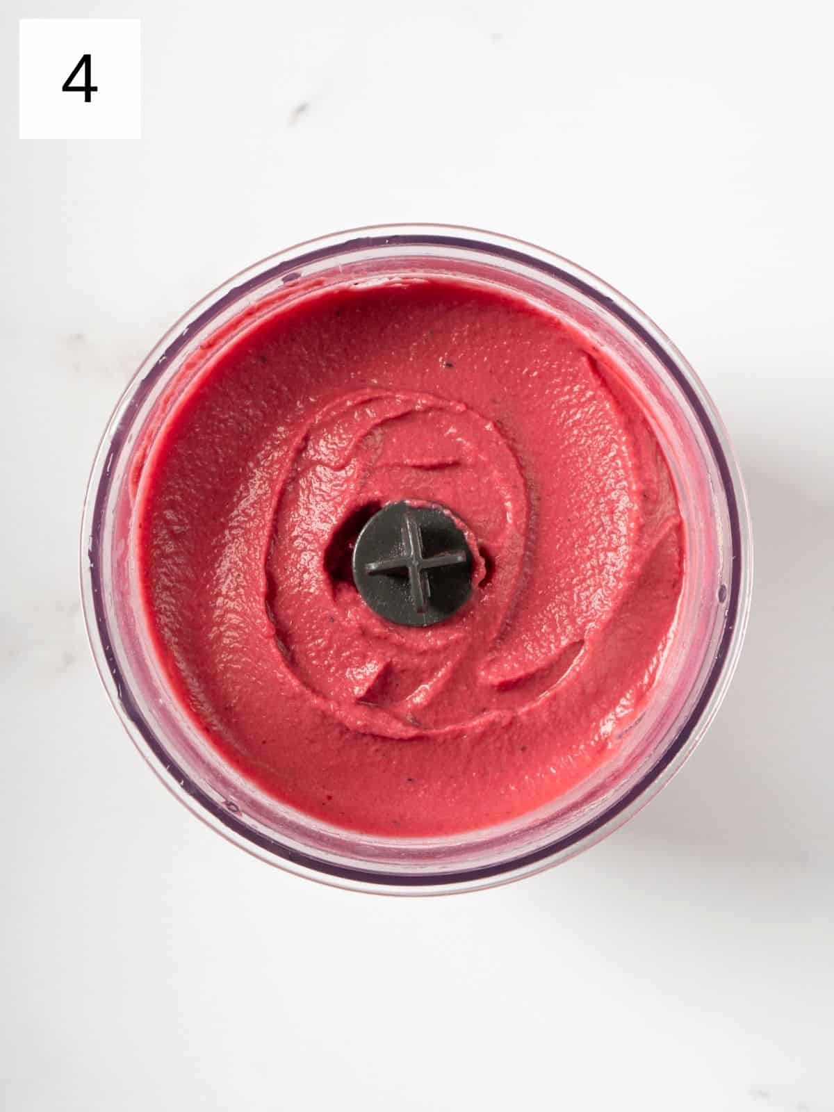 a mixture of beetroot hummus in a food processor.