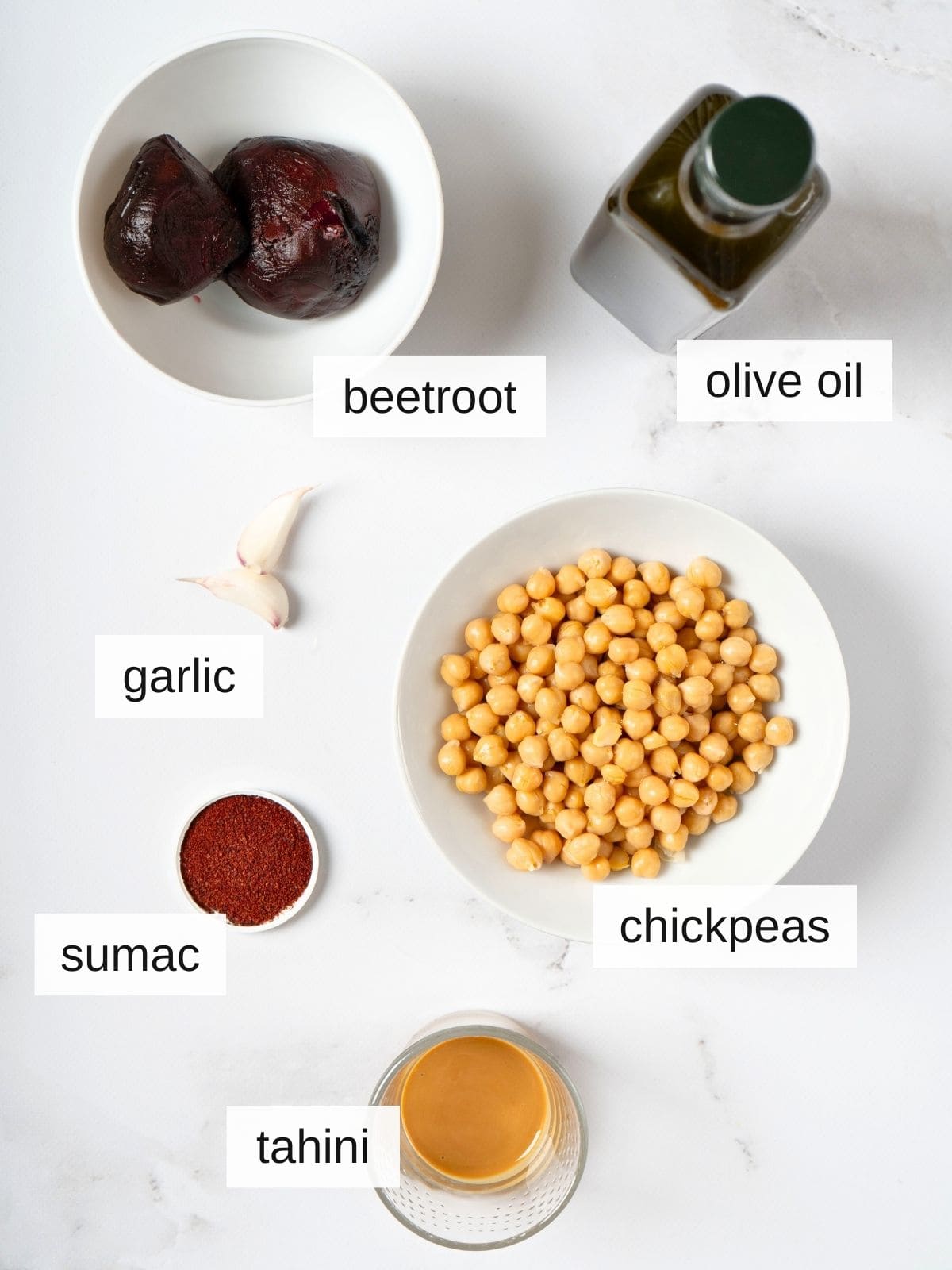ingredients for beetroot hummus, including olive oil, garlic, sumac, tahini, chickpeas, beetroot.