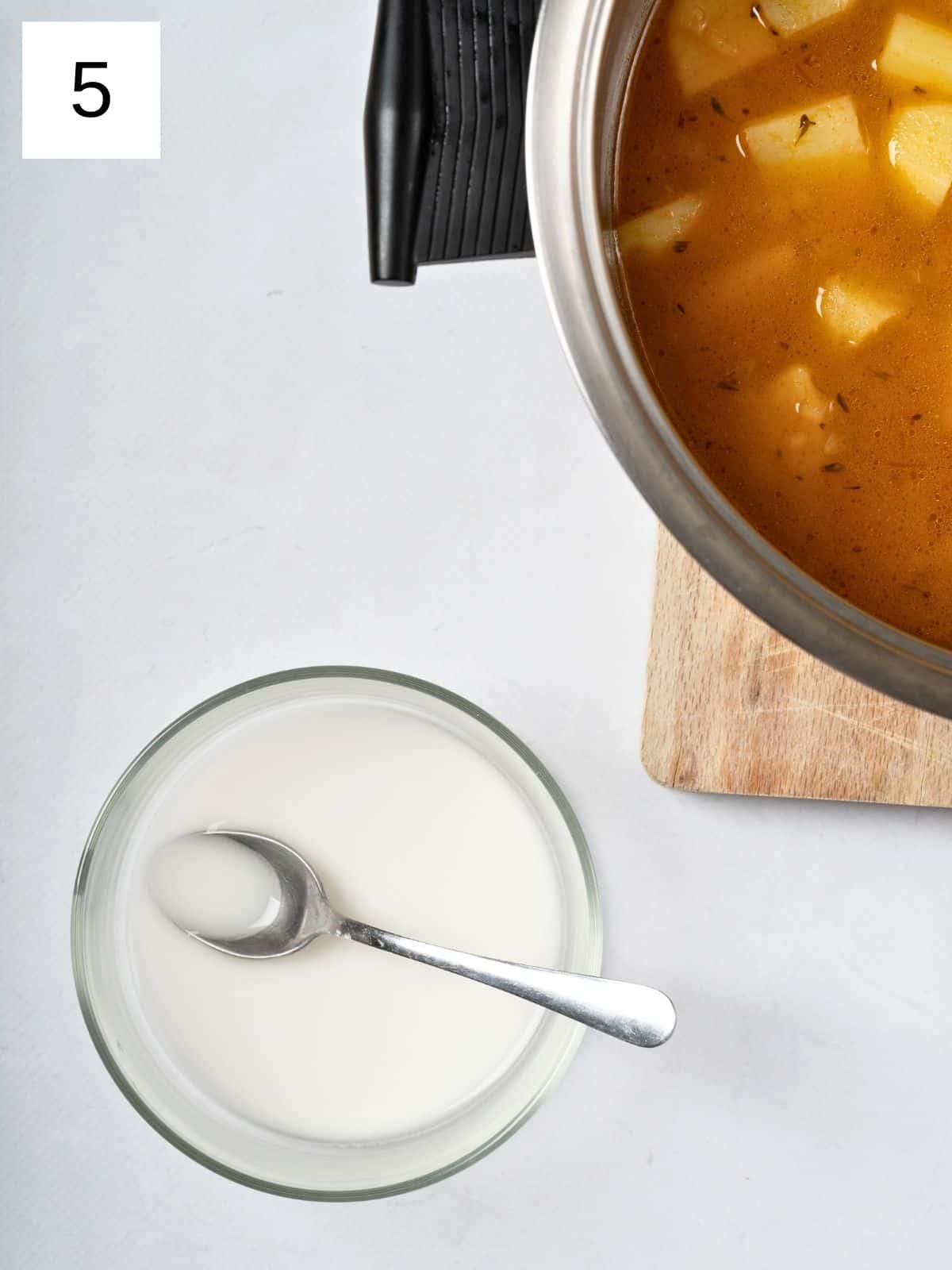 a small bowl of arrowroot starch slurry, ready to be mixed with the potato mixture.