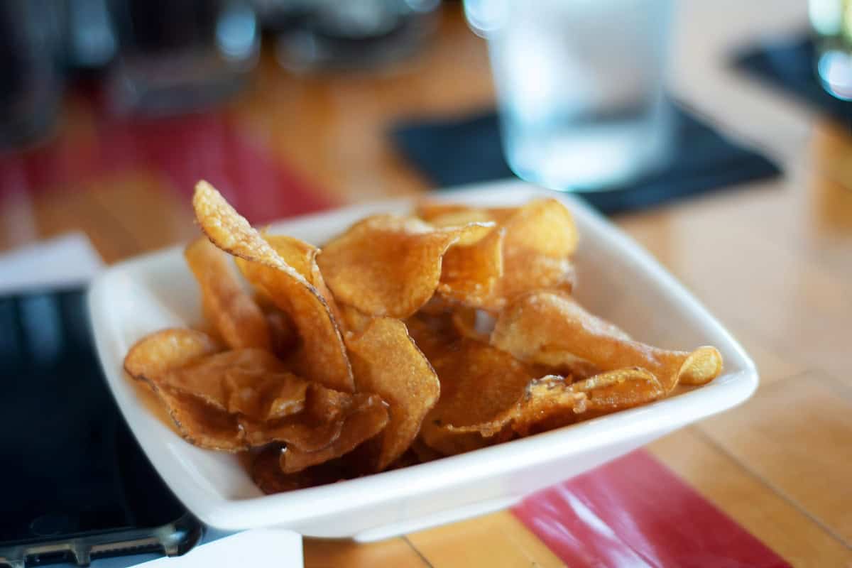 Crispy potato chips on a plate. 