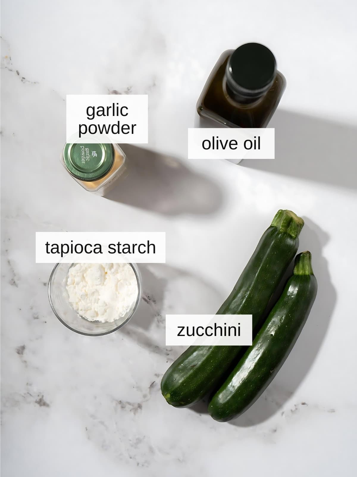 Crispy zucchini fries recipe ingredients with garlic powder, olive oil, tapioca starch, zucchini