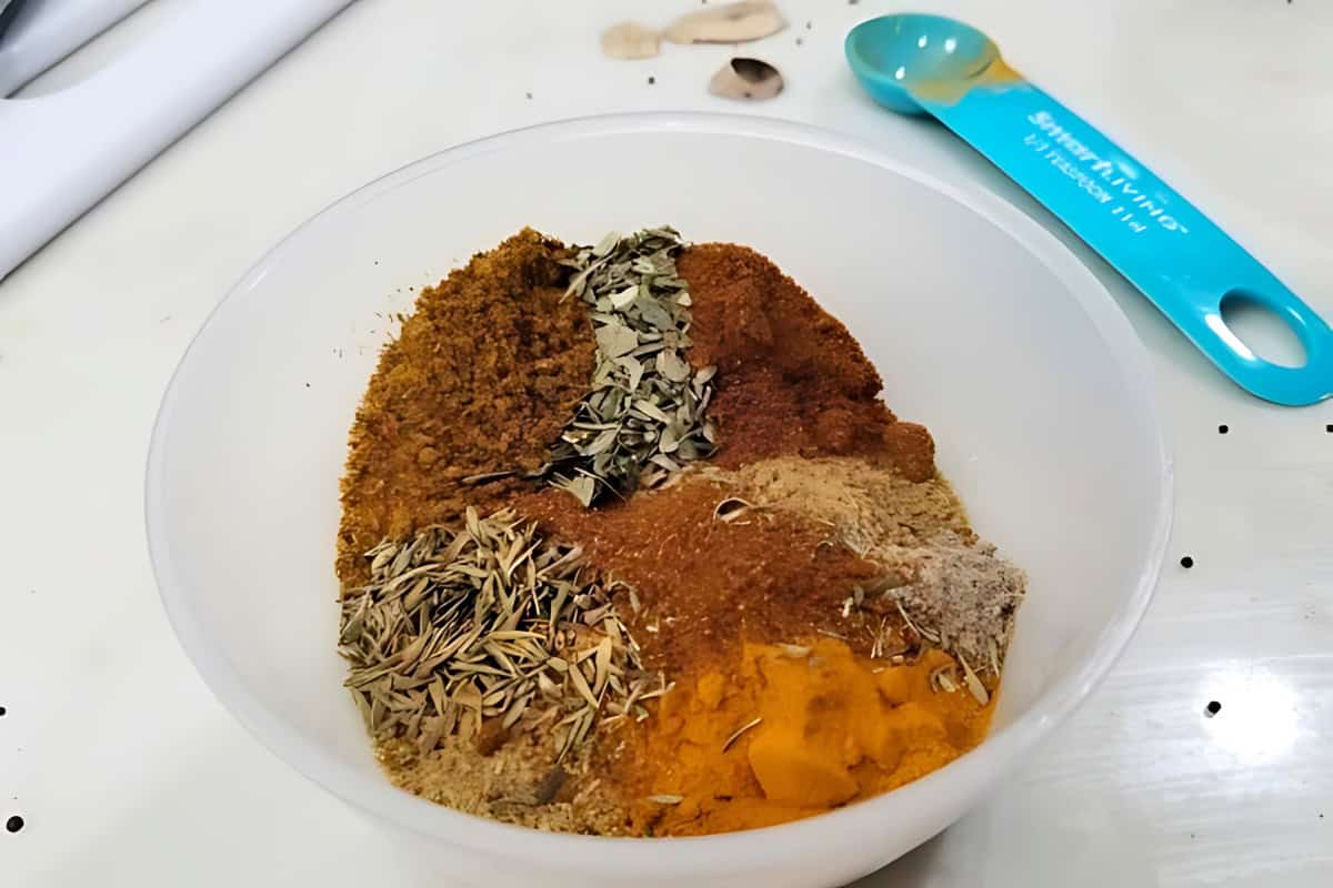 A bowl of different herbs and spices.