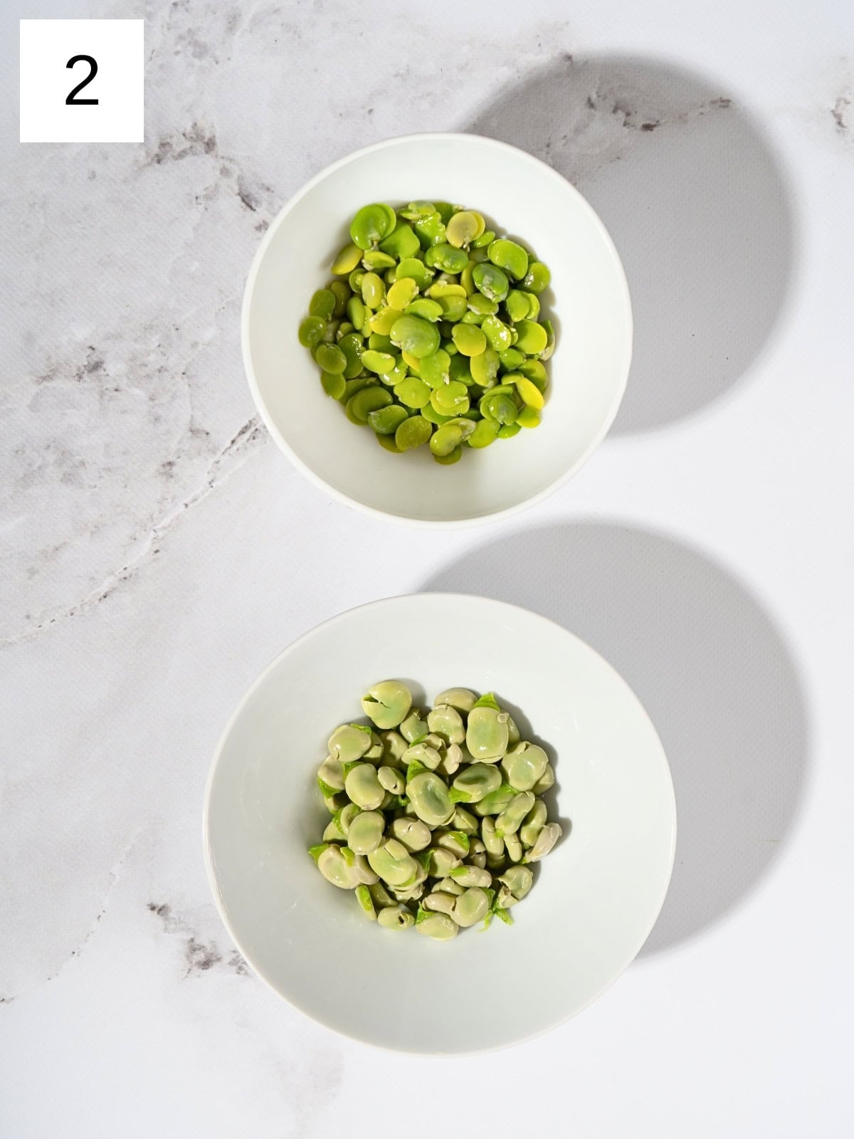 Peeled and de-shelled fava beans separated into bowls.