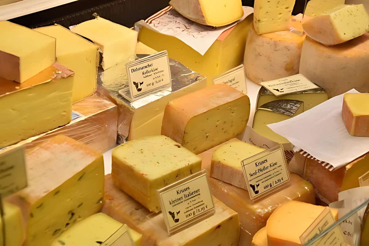 Different kinds of hard cheese being displayed.