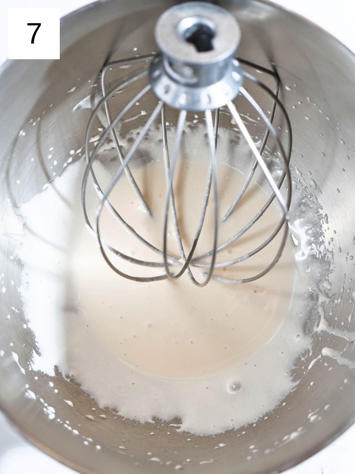 Honey blending in a stand mixer, transforming into a creamy mixture.