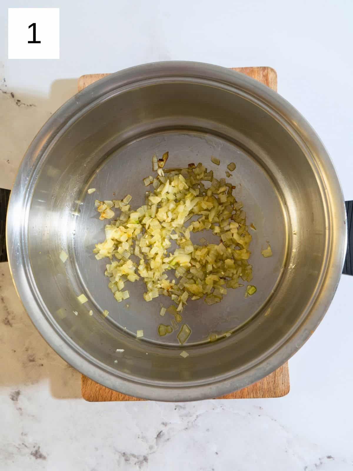 Sautéed chopped onion in a large pot.