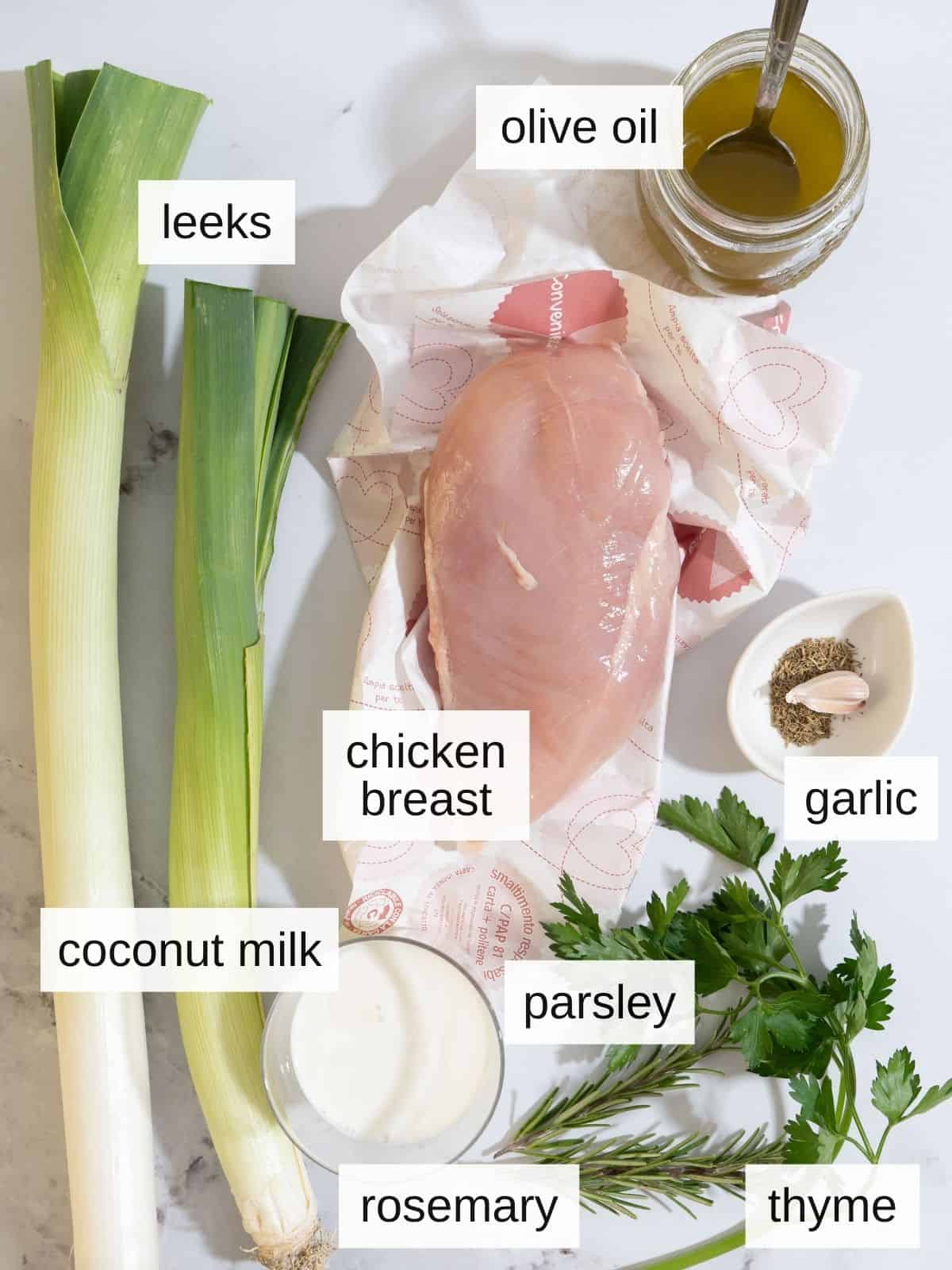 Ingredients for leeks with chicken, including olive oil. chicken breast, coconut milk, garlic, thyme, rosemary, parsley, and leeks.
