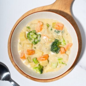 Warm and hearty vegetable stew in a bowl, filled with colorful chunks of vegetables.