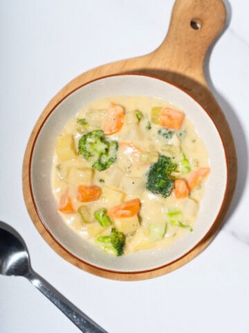 Warm and hearty vegetable stew in a bowl, filled with colorful chunks of vegetables.