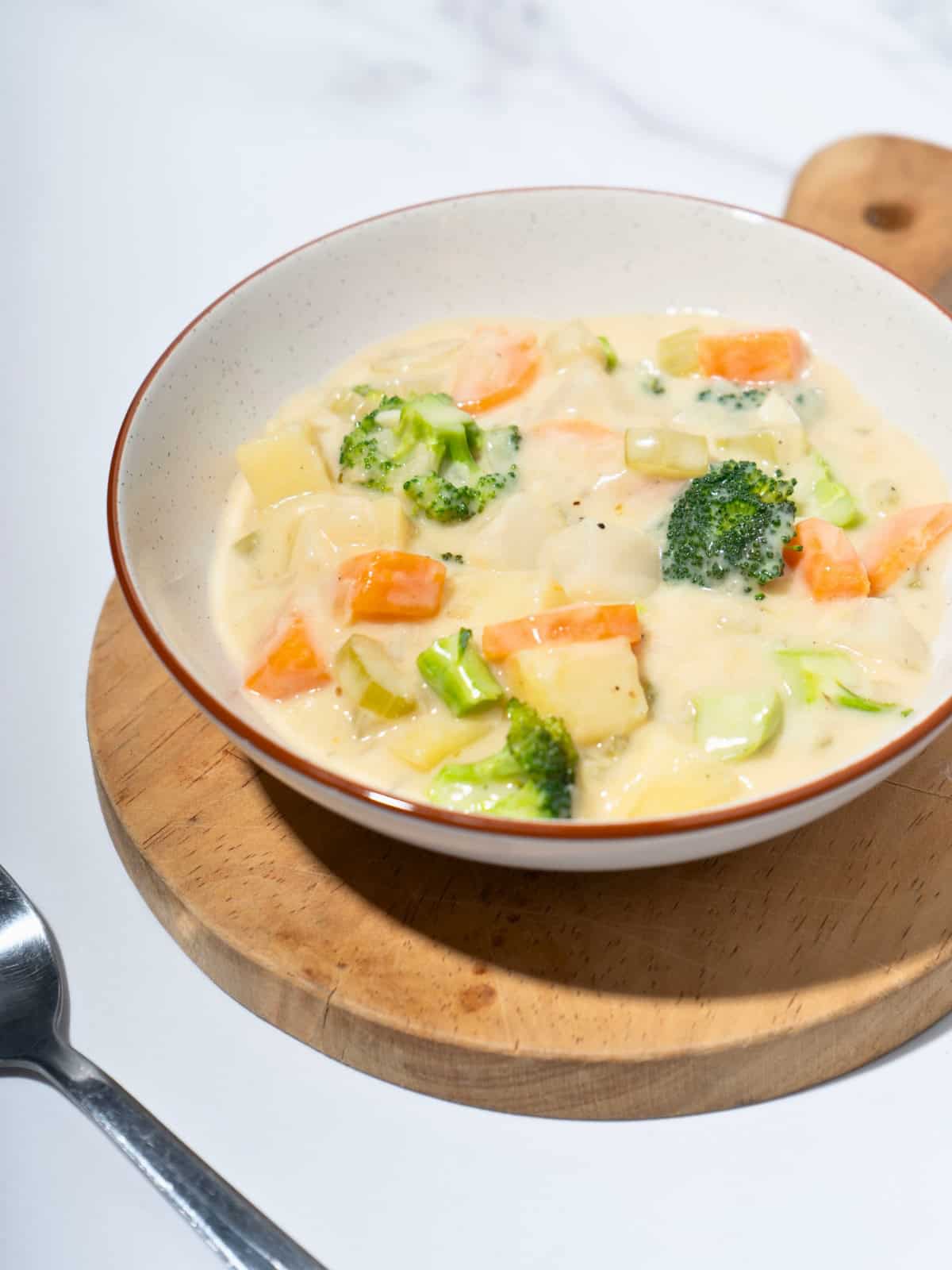 Hearty vegetable stew in a bowl, loaded with vegetables, simmered in a rich, flavorful broth.