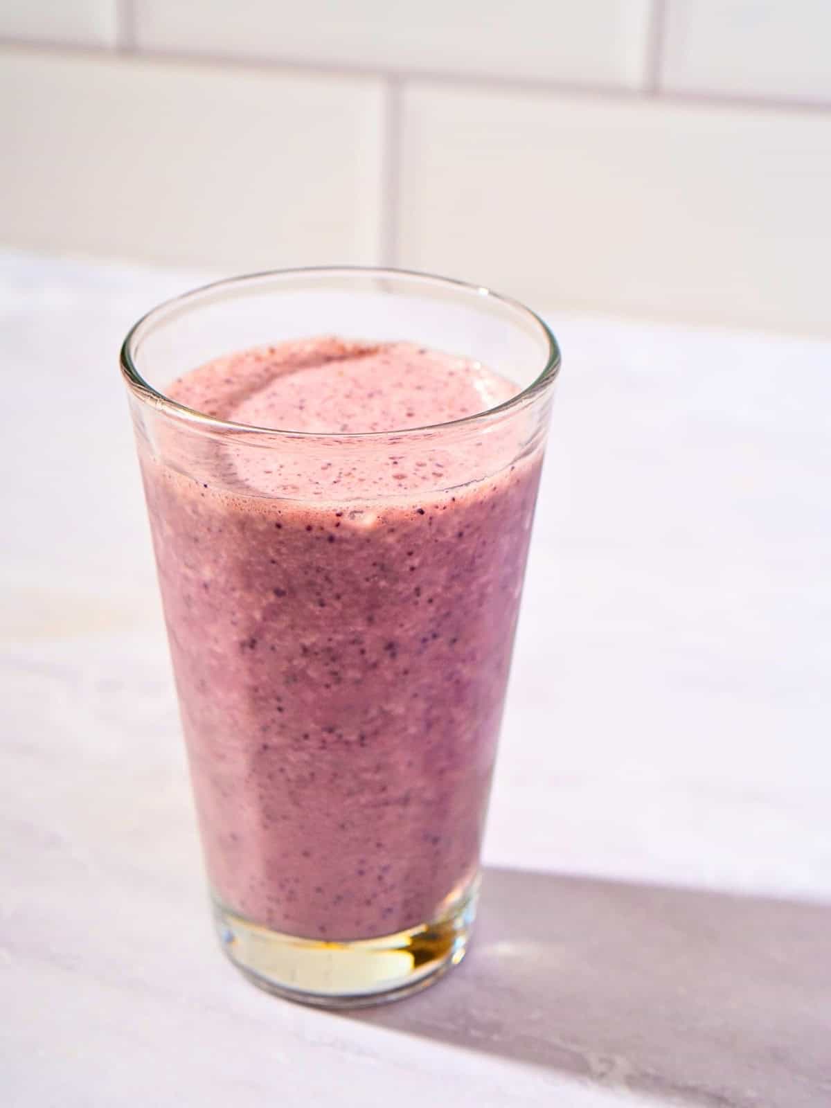 Refreshing blueberry cucumber smoothie served in a glass