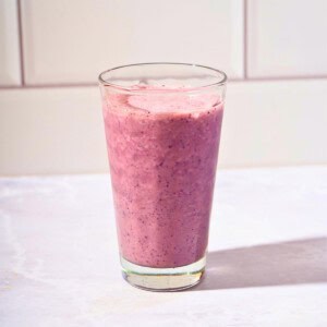 Refreshing blueberry cucumber smoothie served in a glass.