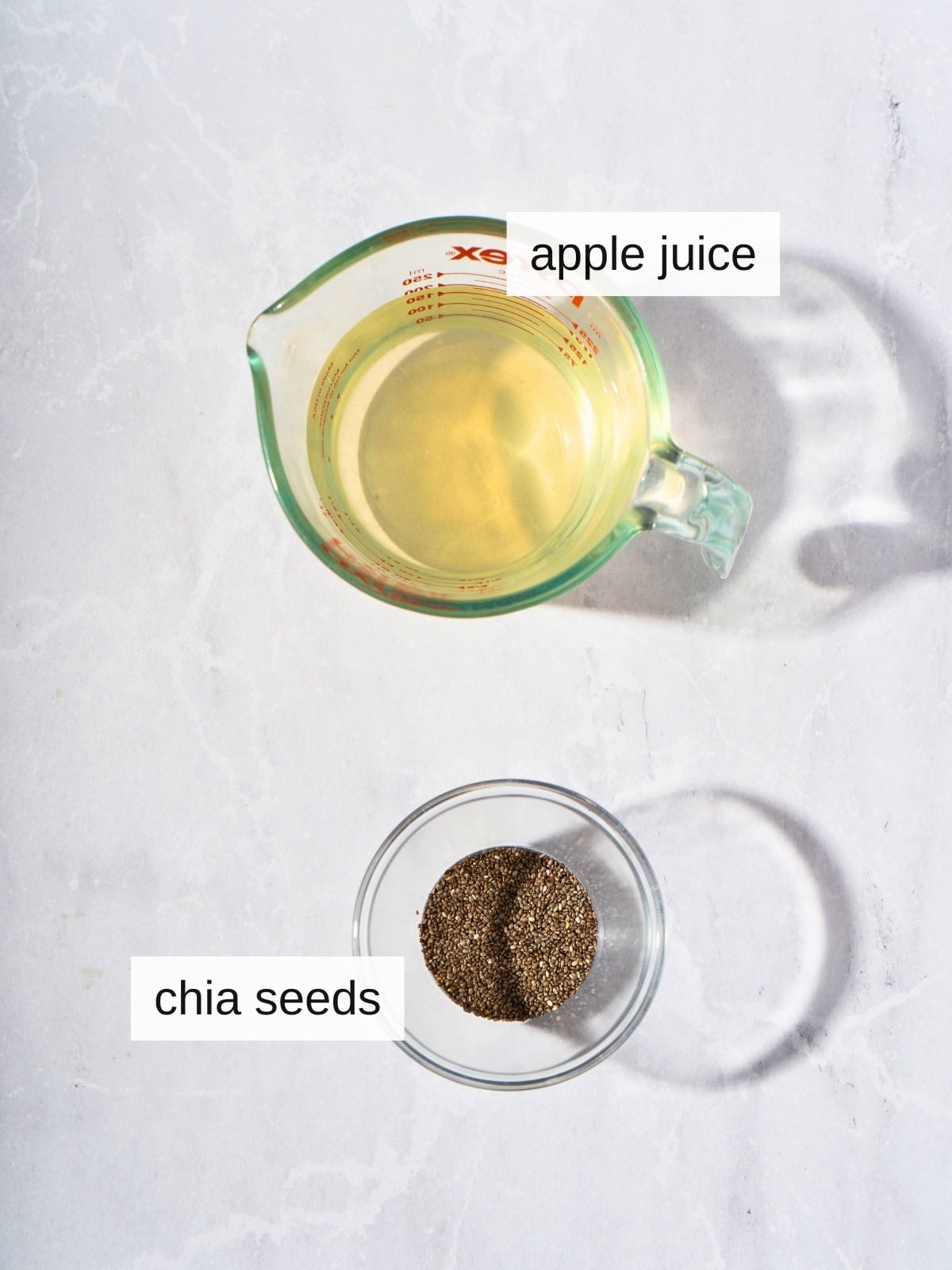 Ingredients for chia apple juice, including apple juice and chia seeds.
