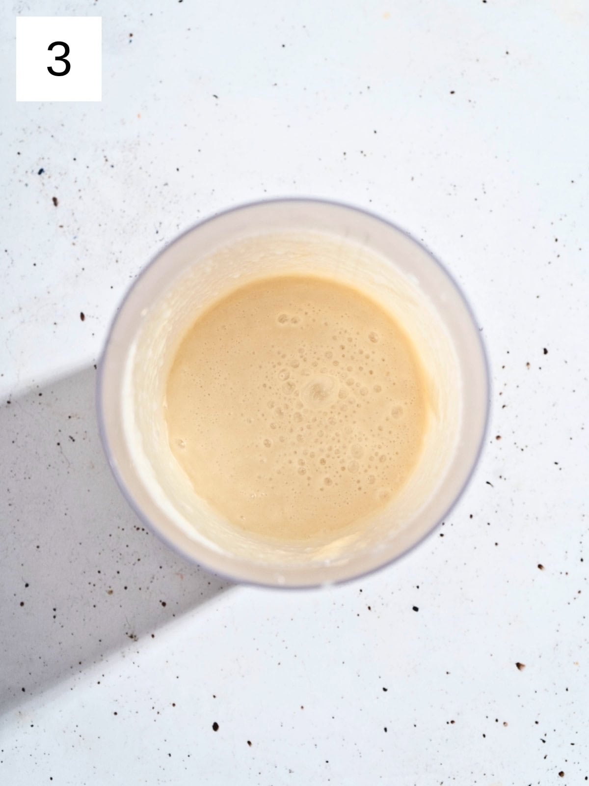 A blended mixture of ginger garlic sauce in a food processor.