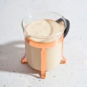 Thick and flavorful creamy ginger garlic sauce displayed in a glass jar.