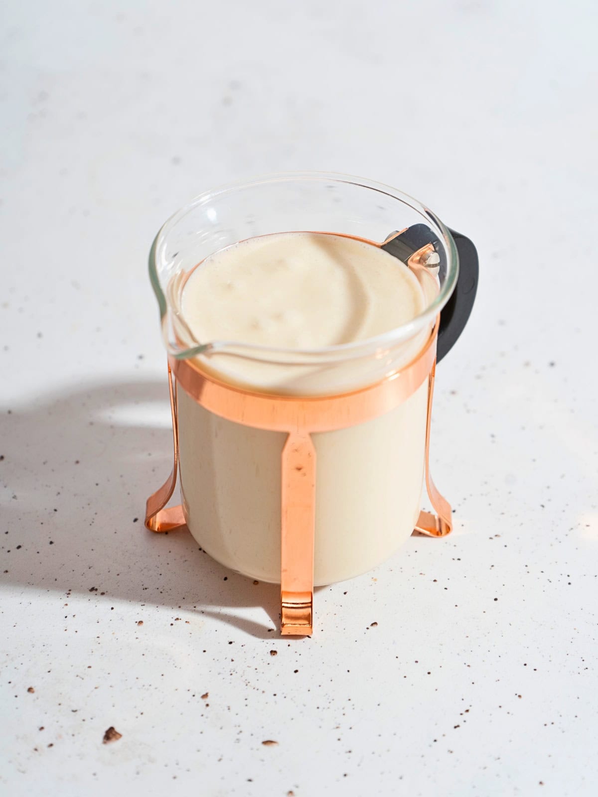 Thick and flavorful creamy ginger garlic sauce displayed in a glass jar.