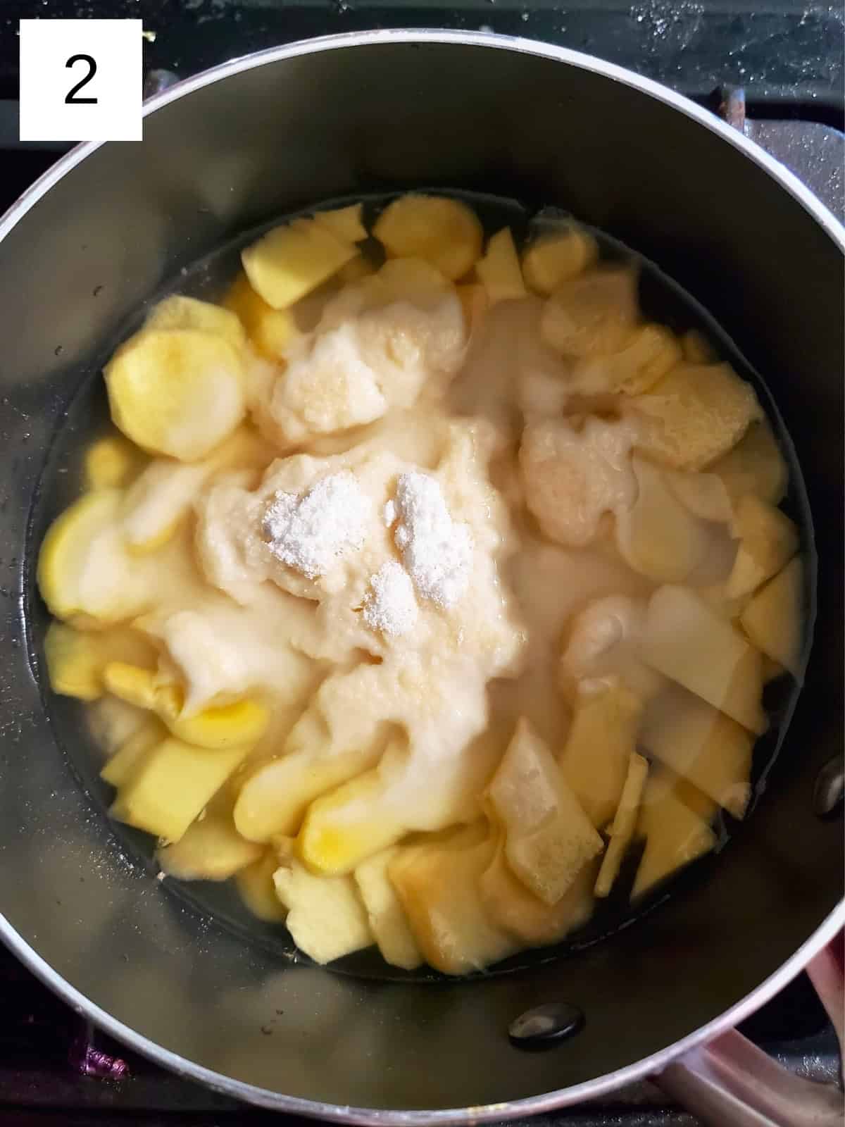 a mixture of ginger, water, and sweeteners in a pot.