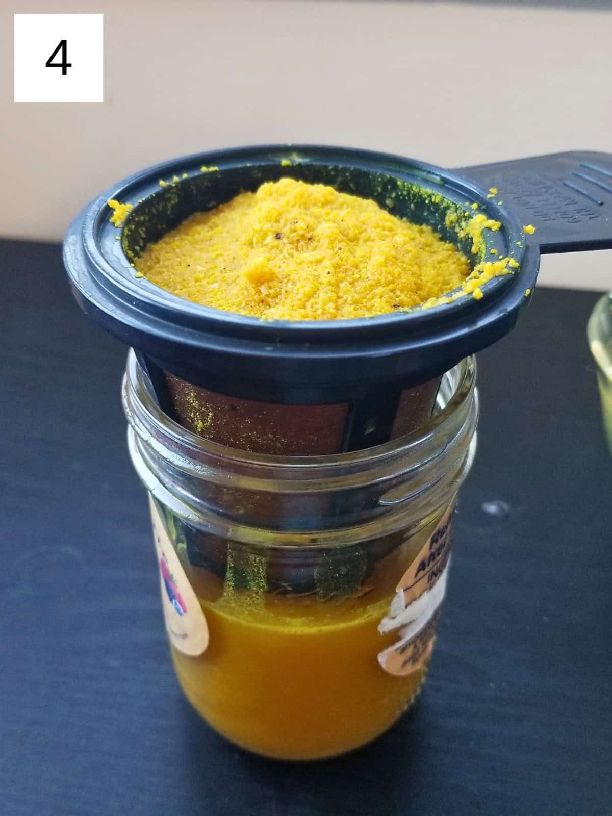 Step 3 for making Ginger Turmeric Shots: filtering the mixture to create a smooth ginger shot.