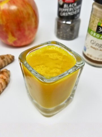 vibrant ginger turmeric shots served in small glass containers, showcasing the 15-minute ginger turmeric shot recipe without lemon.