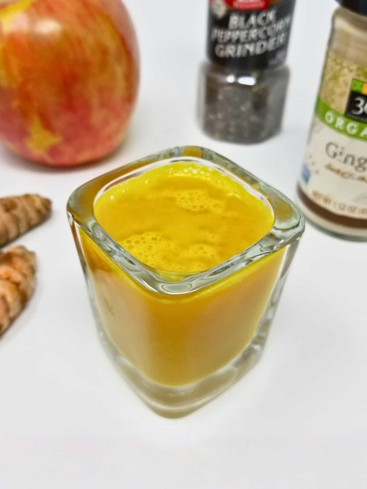 vibrant ginger turmeric shots served in small glass containers, showcasing the 15-minute ginger turmeric shot recipe without lemon.