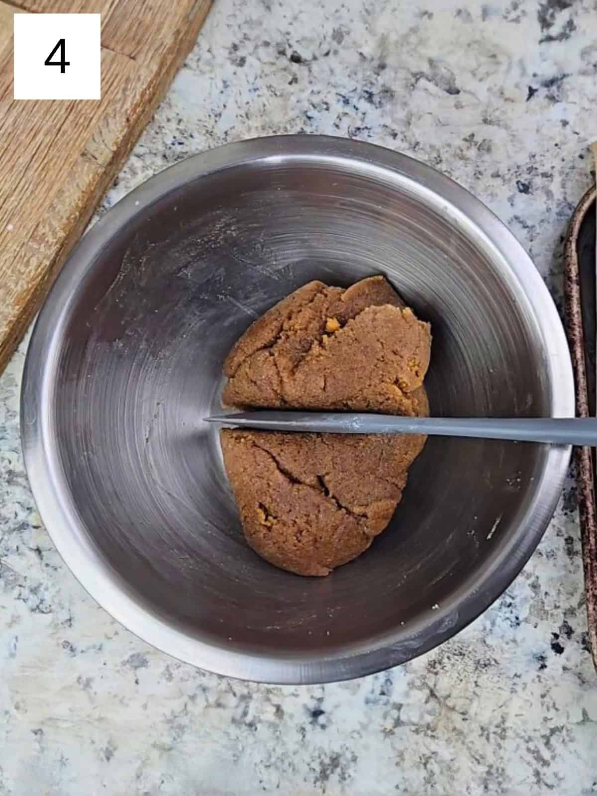 A mixture of cookie dough in a mixing bowl.