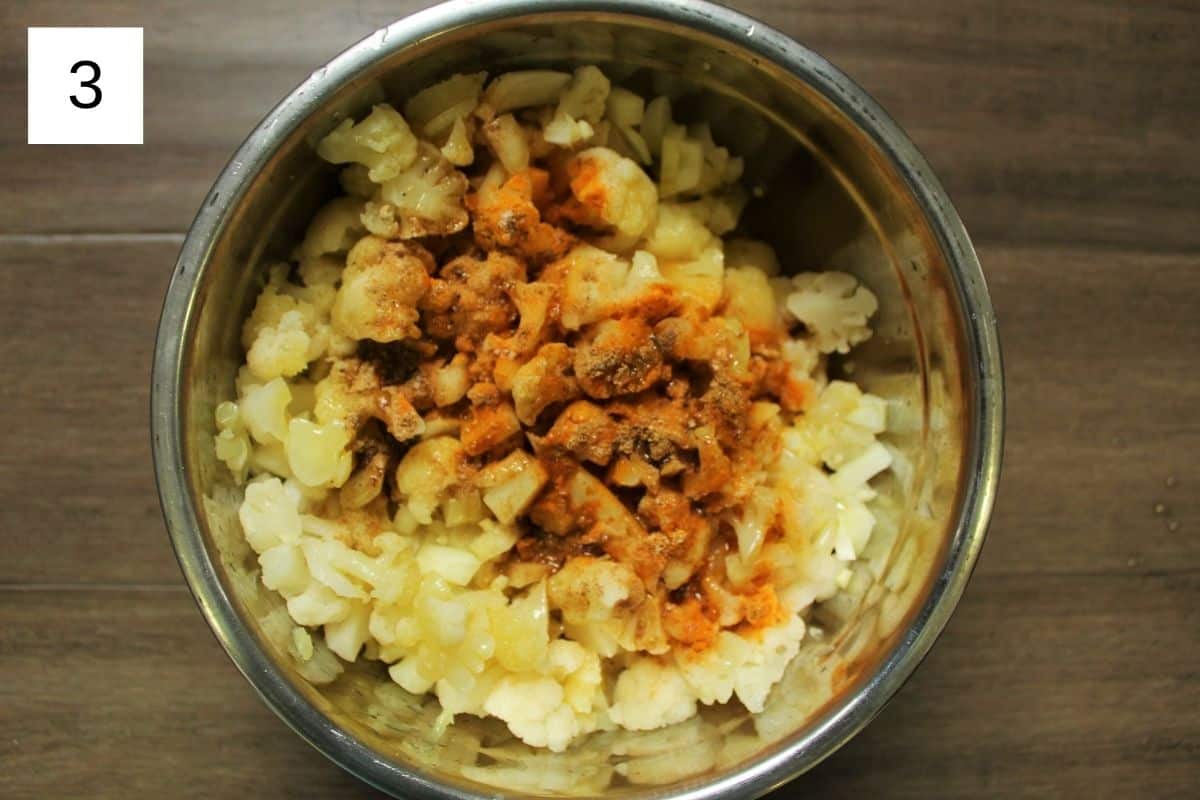 Ingredients for crispy baked cauliflower in a mixing bowl, showcasing a simple preparation step for delicious baked cauliflower.