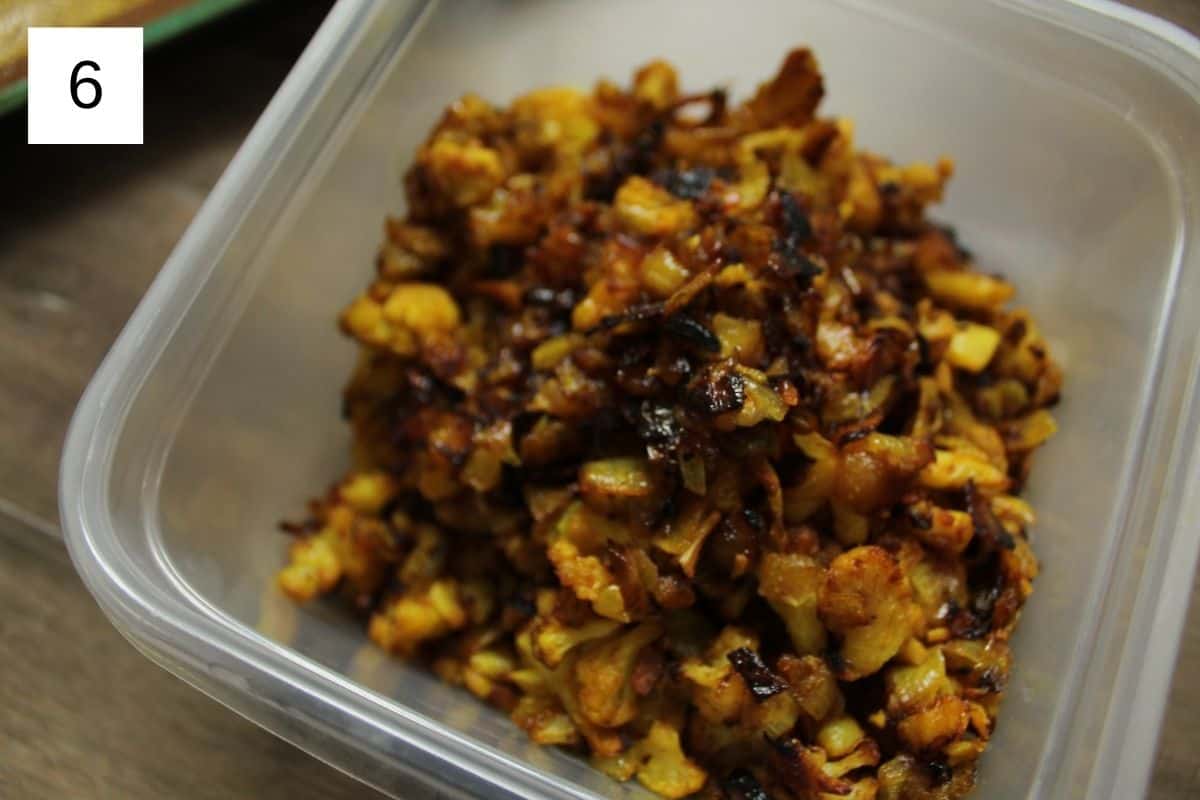 Baked cauliflower in a plastic container, showcasing its crispy texture, ready to serve as a delicious snack or side dish.