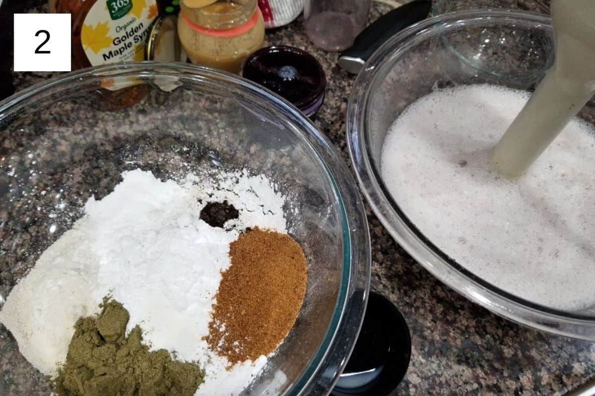 A mixture of all the dry ingredients in a glass bowl, including flour, sea salt, vanilla powder, baking powder, coconut sugar, and protein powder.