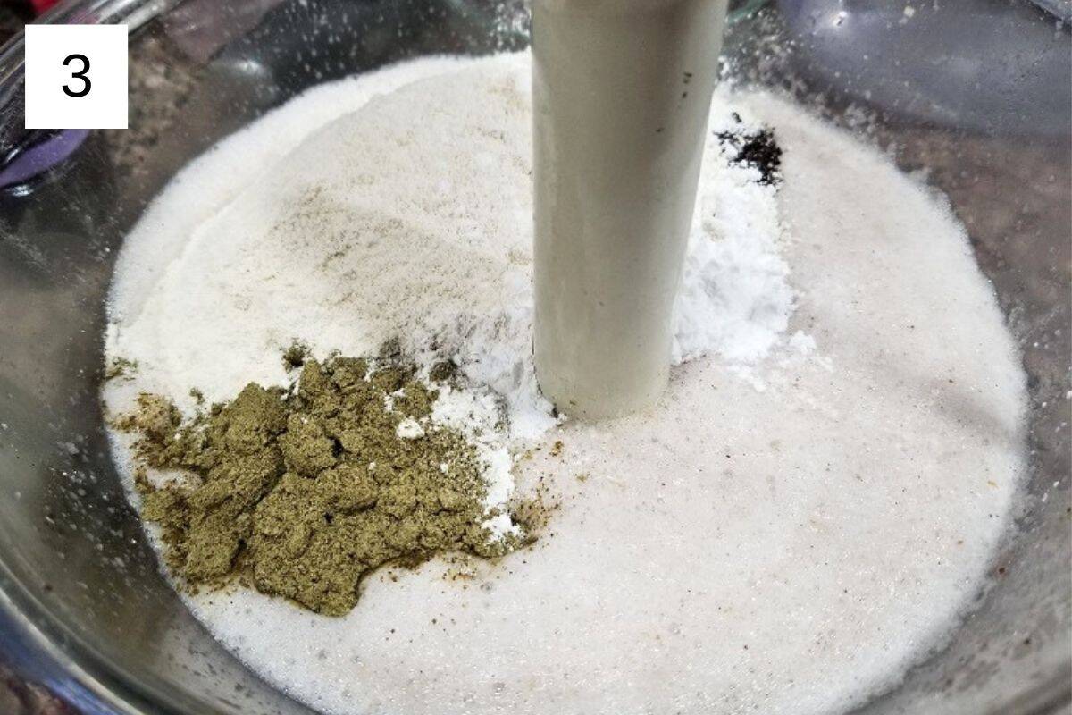 A mixture of dry and wet ingredients for oat milk pancakes in a glass bowl.