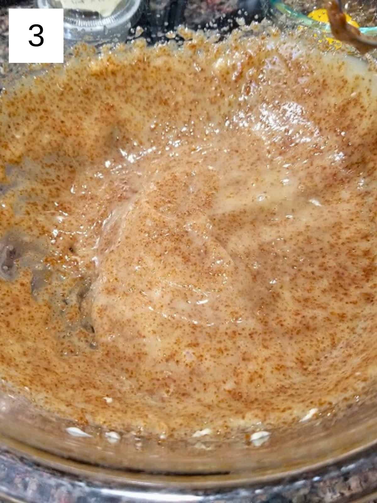 Creamed mixture of butter, coconut sugar, and honey in a glass mixing bowl.