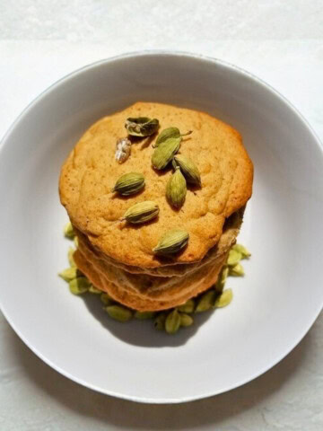 A stack of honey cardamom cookies on a plate.