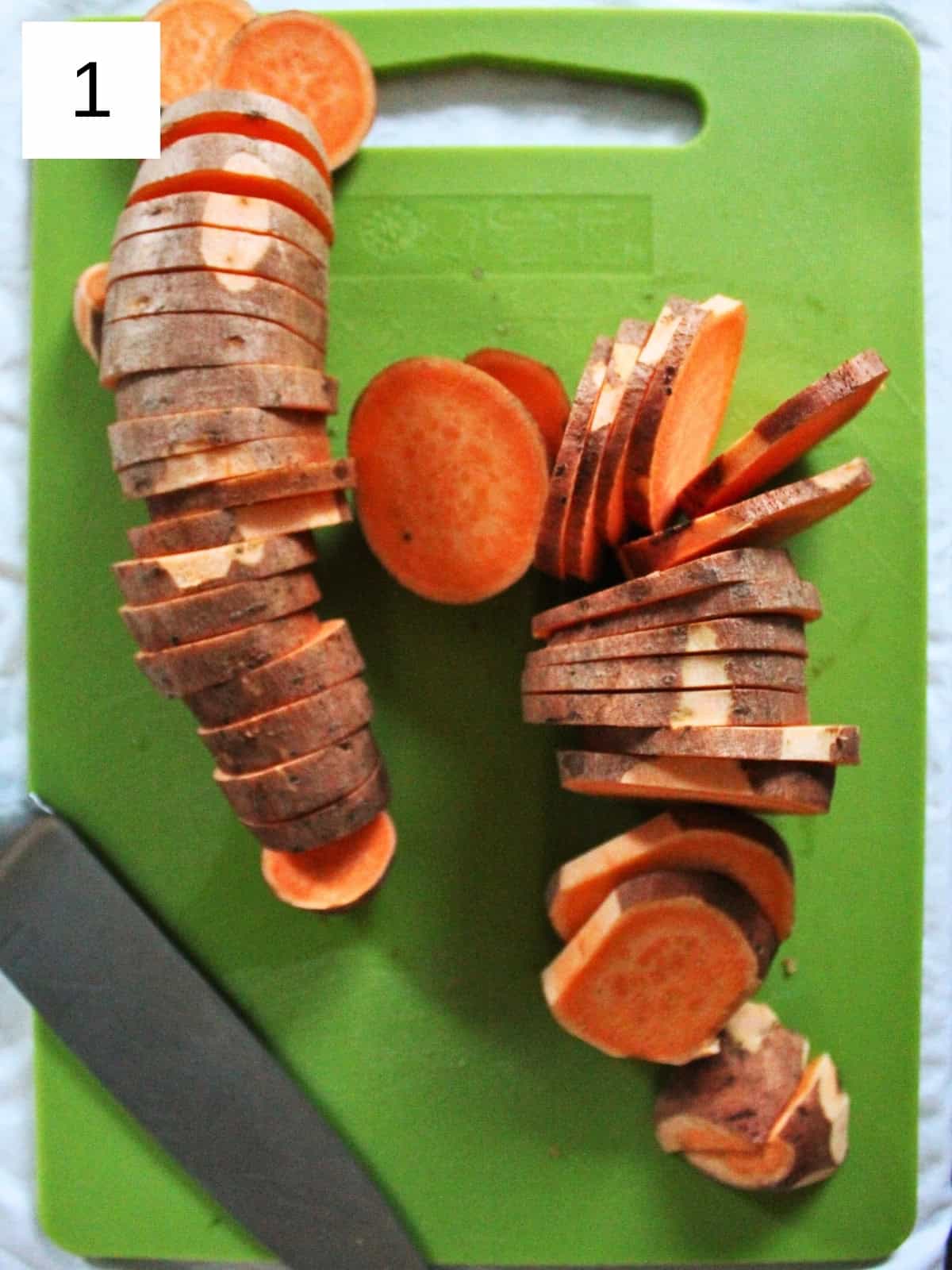 equally sliced sweet potatoes on a green cutting board.