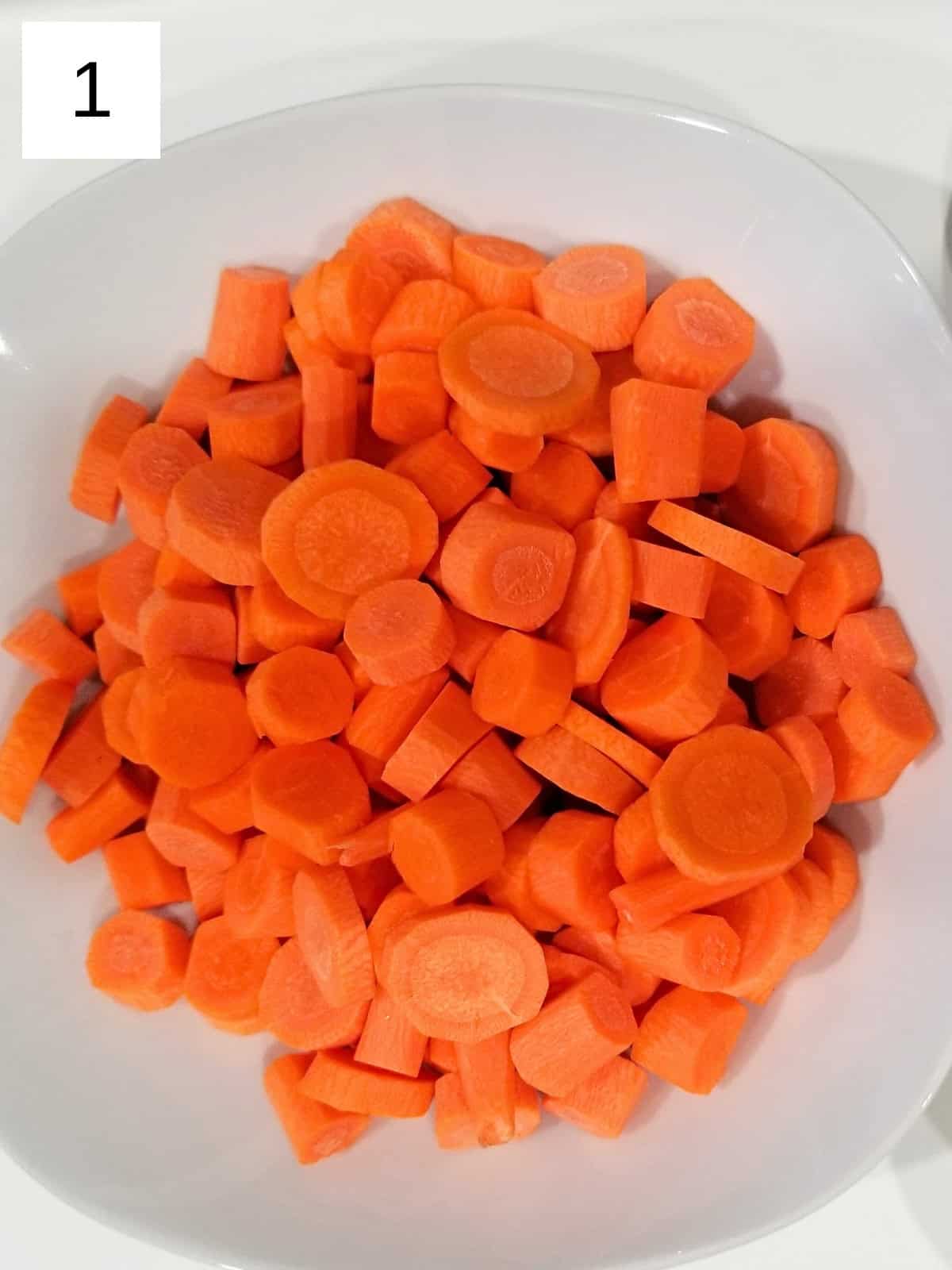 Raw carrot slices on a plate.