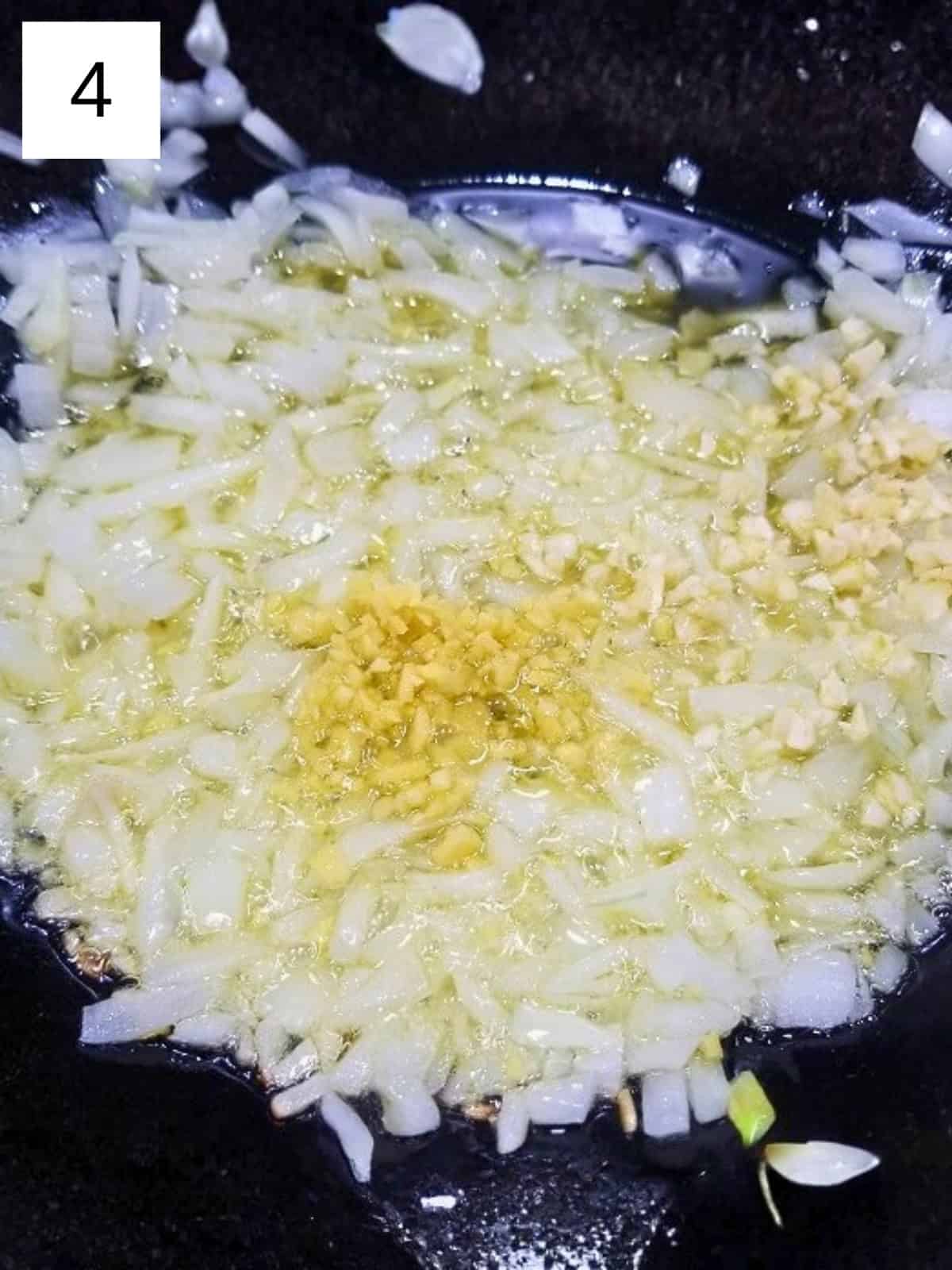 Sauteed chopped onions, garlic, and ginger in a pan.
