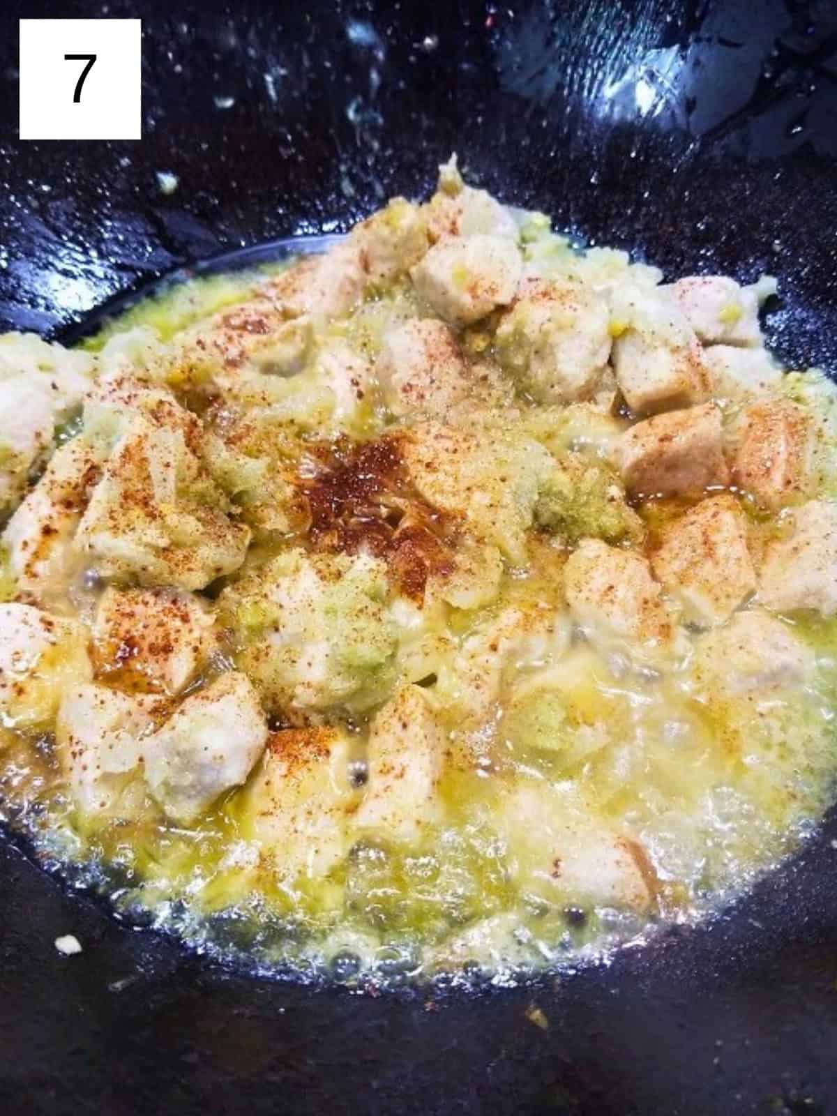 Cooked lemongrass chicken pieces in a pan, topped with coconut sugar.