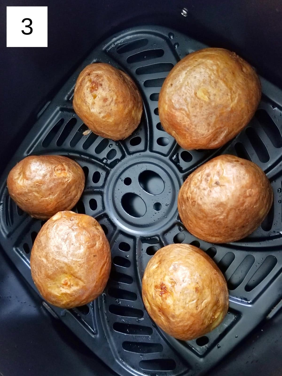 Air fried potatoes in an air fryer basket.